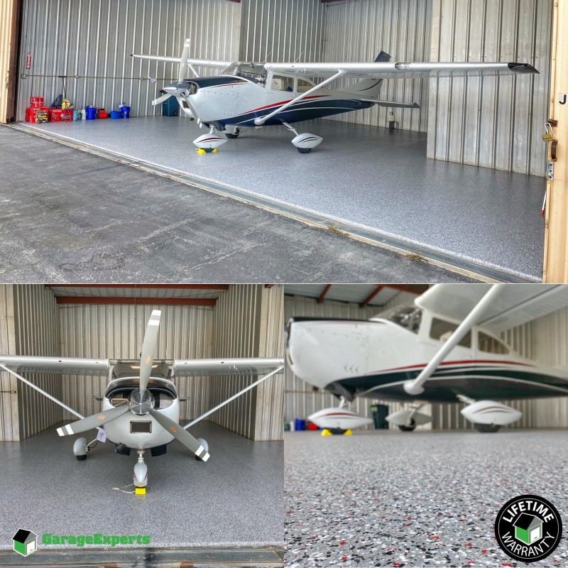 single propeller plane inside hanger with a focus on the high quality floor