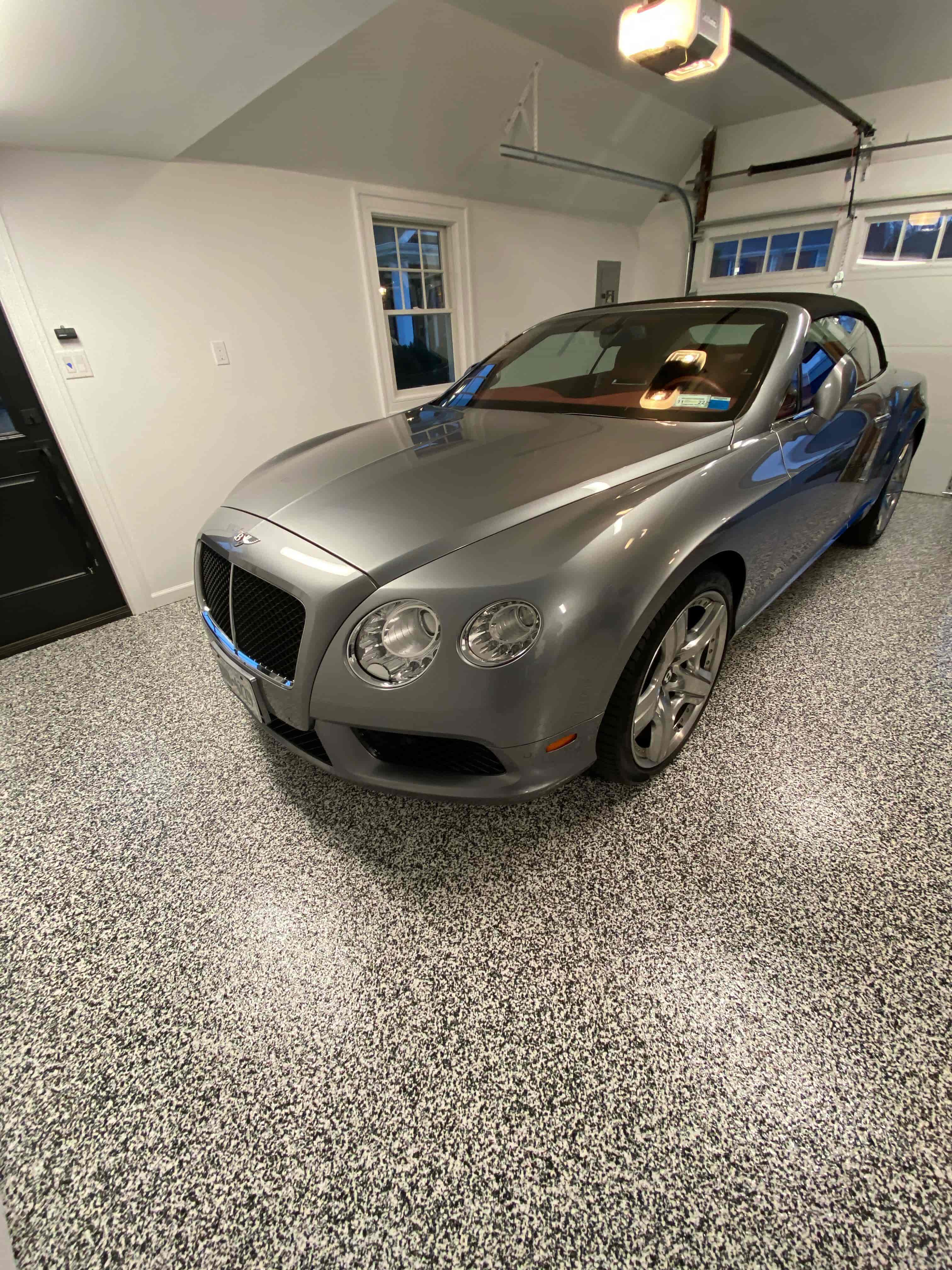 epoxy and polyaspartic garage flooring with car 