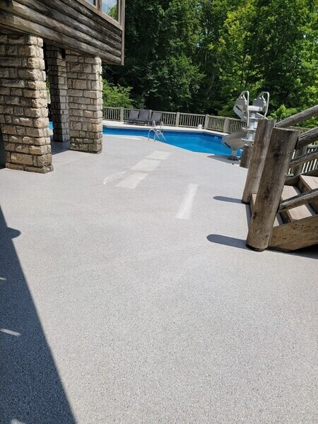 Concrete coating on a flooring surrounding an outdoor pool.