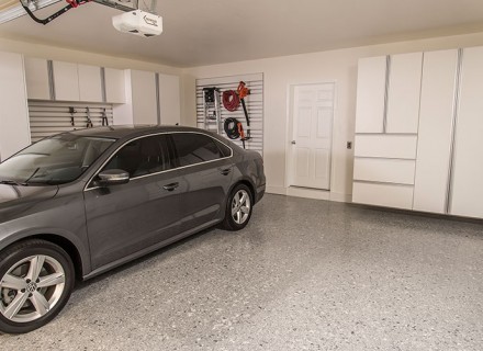 Epoxy flooring in a garage with cabinets