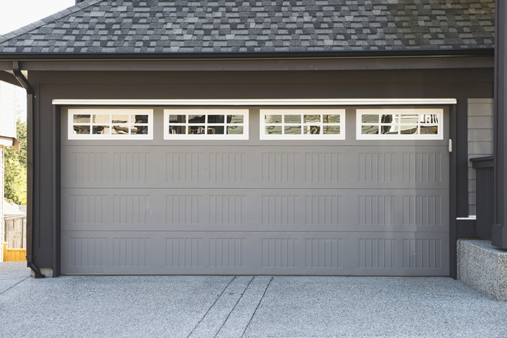 Grey garage door with white windows. 